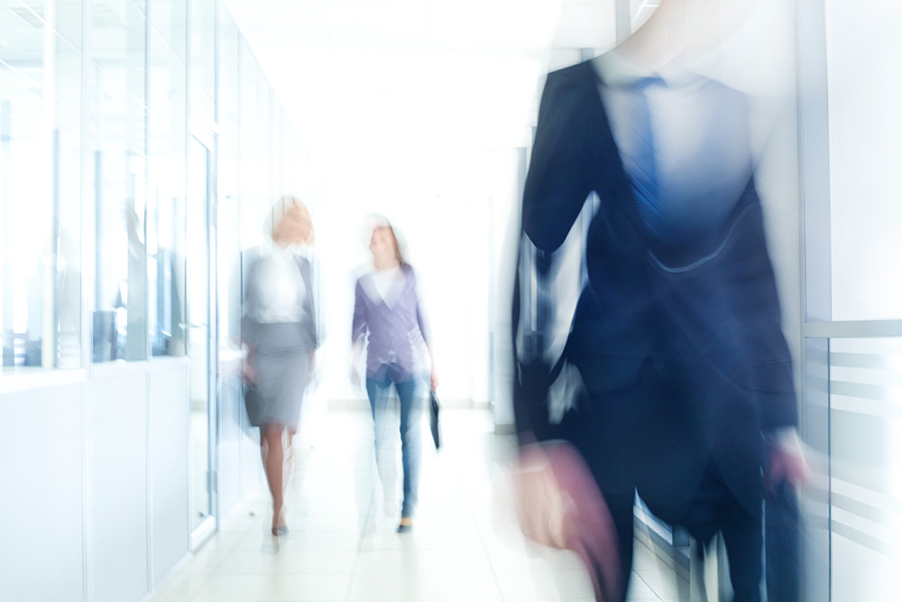 Image of people walking down a hallway on Nemphos Braue's website