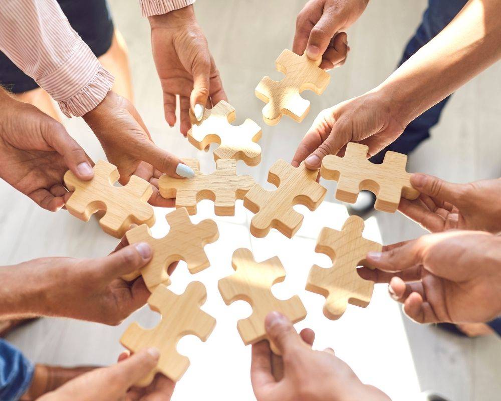 Image of people putting puzzle pieces together