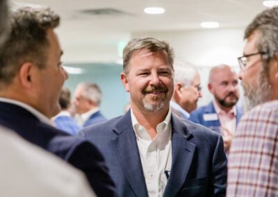 Image of men having a conversation and smiling at NB summer social