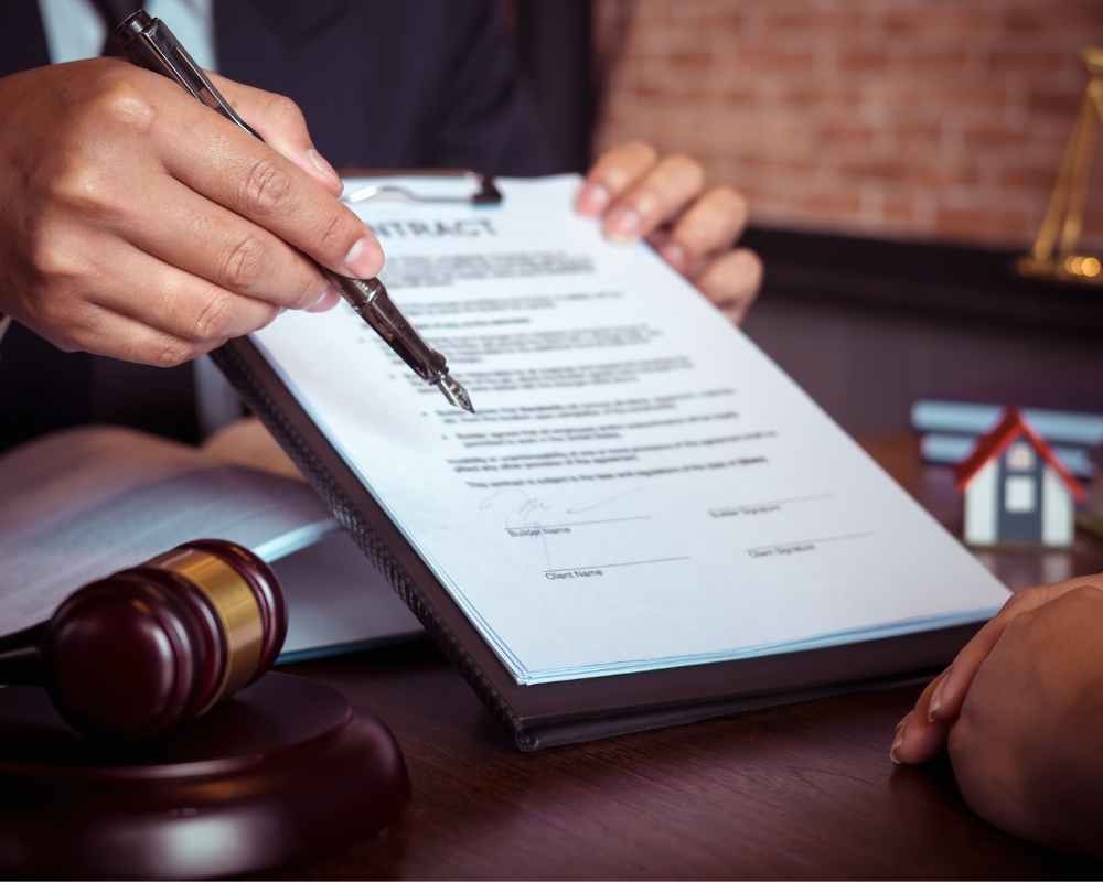 Image of a contract with a person holding a pen out to another
